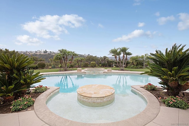 view of swimming pool with an in ground hot tub