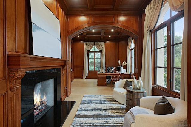 interior space with crown molding, coffered ceiling, wood ceiling, and wooden walls