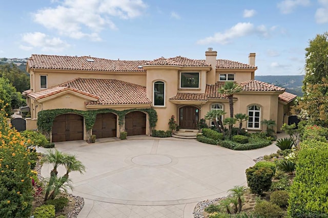 mediterranean / spanish-style home featuring a garage