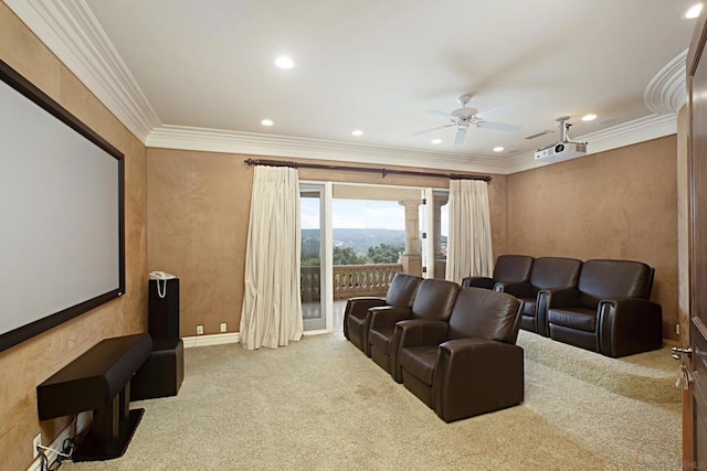 carpeted home theater with ceiling fan and ornamental molding