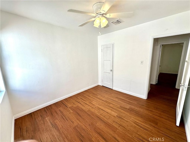 unfurnished bedroom featuring a closet, hardwood / wood-style flooring, and ceiling fan