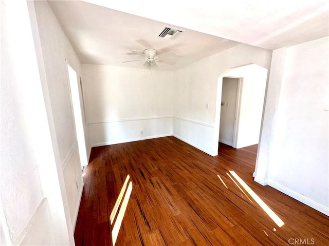 empty room with ceiling fan and dark hardwood / wood-style floors