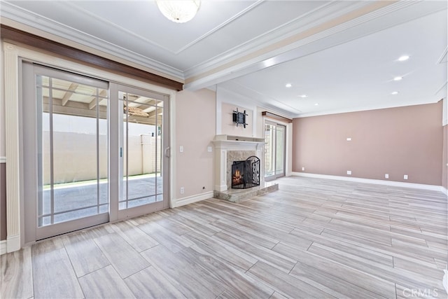 unfurnished living room with ceiling fan, light hardwood / wood-style flooring, ornamental molding, and a high end fireplace