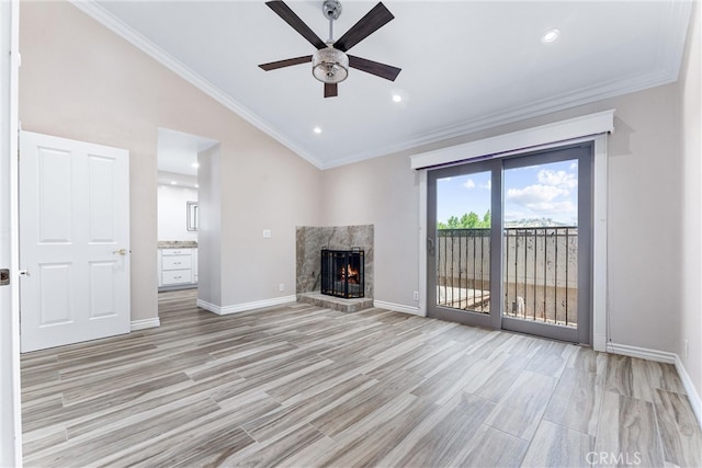 unfurnished living room featuring ceiling fan, a fireplace, crown molding, and light hardwood / wood-style flooring