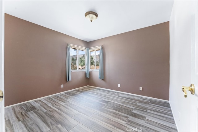 spare room featuring wood-type flooring