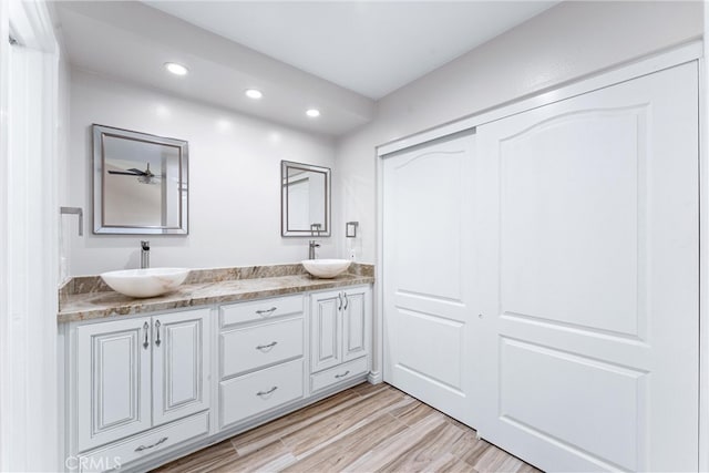 bathroom with wood-type flooring and vanity