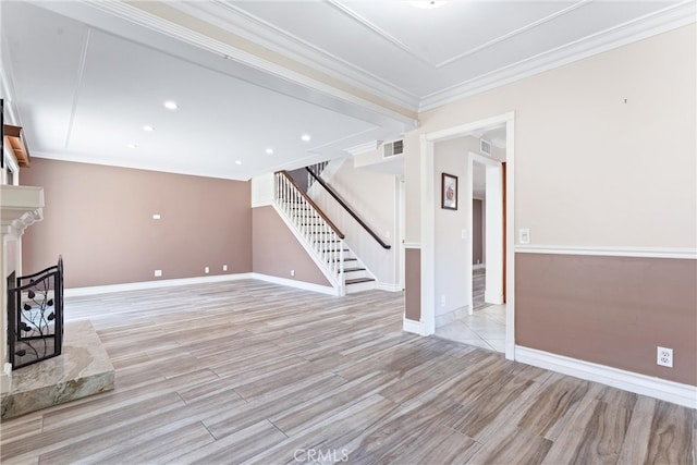 unfurnished living room featuring light hardwood / wood-style flooring, a premium fireplace, and ornamental molding