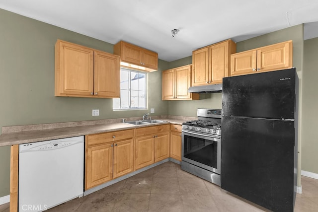 kitchen featuring black fridge, light tile patterned flooring, sink, gas range, and dishwasher