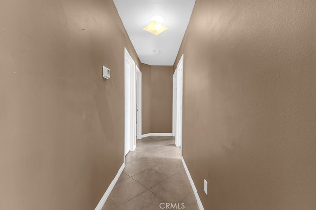 corridor with light tile patterned flooring