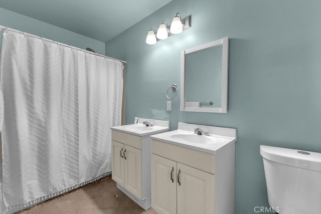 bathroom with a shower with shower curtain, vanity, toilet, and tile patterned floors