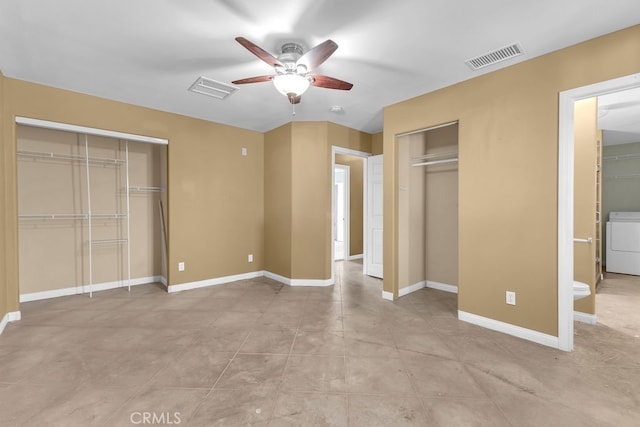 unfurnished bedroom featuring ceiling fan, multiple closets, connected bathroom, and washer / dryer