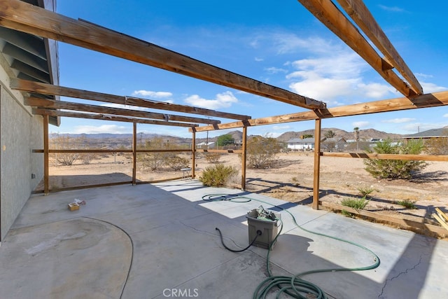 view of patio / terrace featuring a mountain view