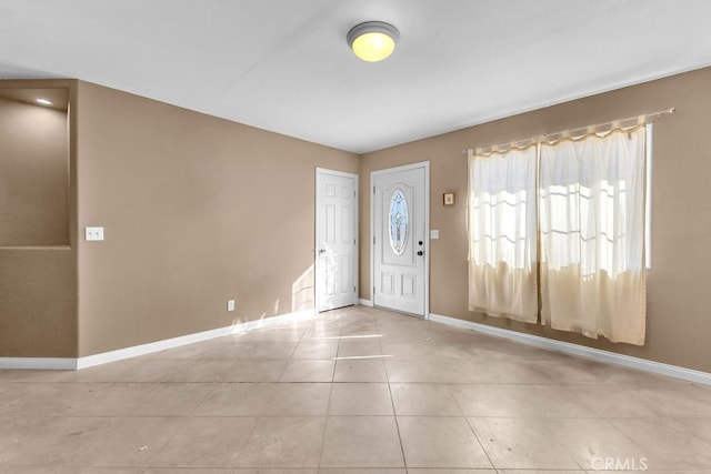 foyer entrance with light tile patterned flooring