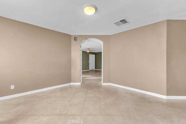 tiled empty room with ceiling fan