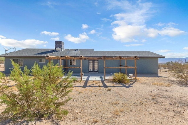 rear view of property with french doors and central AC unit