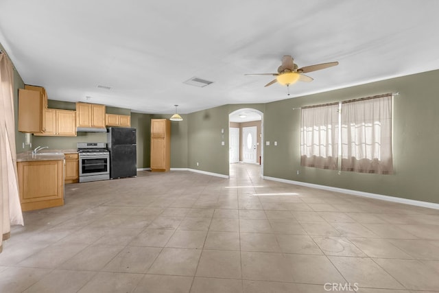 kitchen with hanging light fixtures, light tile patterned flooring, stainless steel range oven, ceiling fan, and black fridge