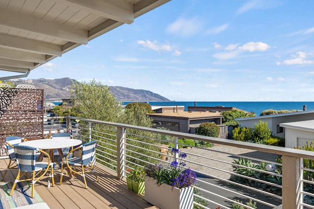 balcony with a water and mountain view