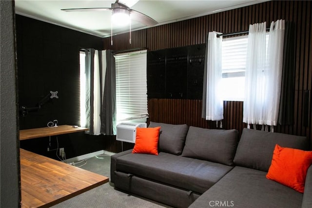 carpeted living room featuring ceiling fan and ornamental molding