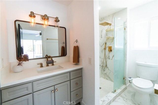 bathroom featuring vanity, ceiling fan, toilet, and a shower with door