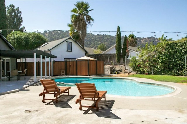 view of pool featuring a patio area and a mountain view