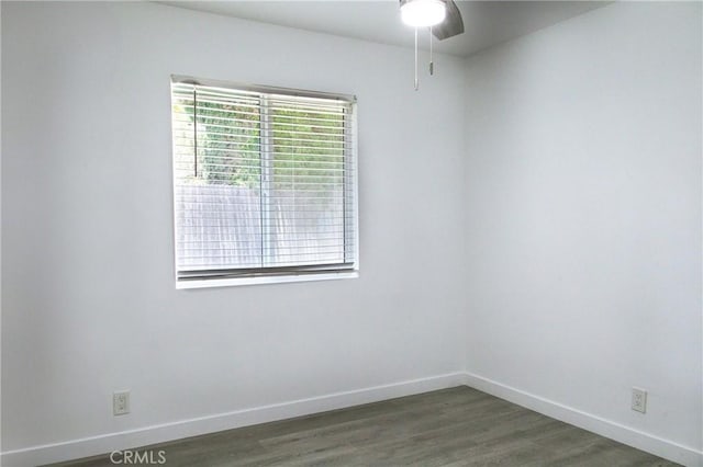 empty room with ceiling fan and dark hardwood / wood-style floors