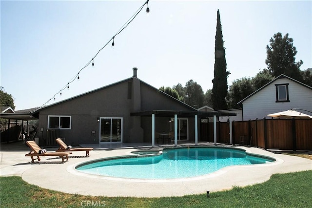 view of swimming pool with a patio area and an in ground hot tub