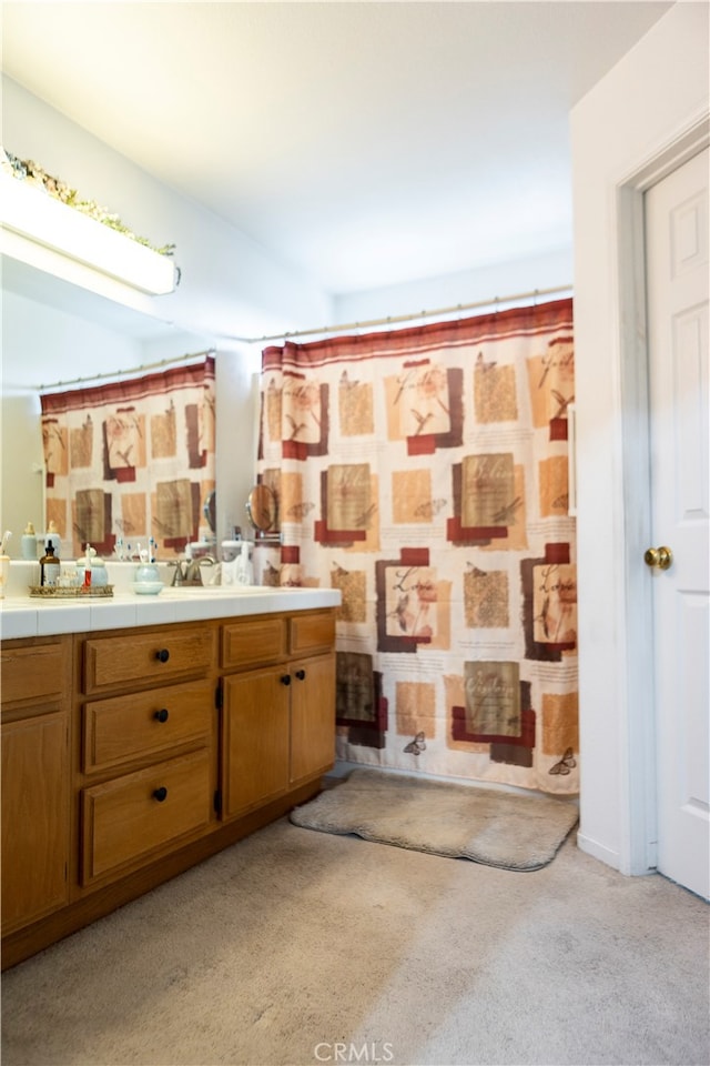 bathroom featuring vanity and a shower with shower curtain