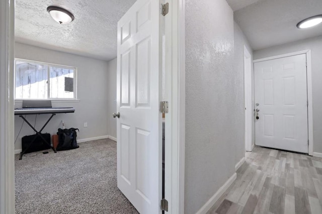 hall with light hardwood / wood-style floors