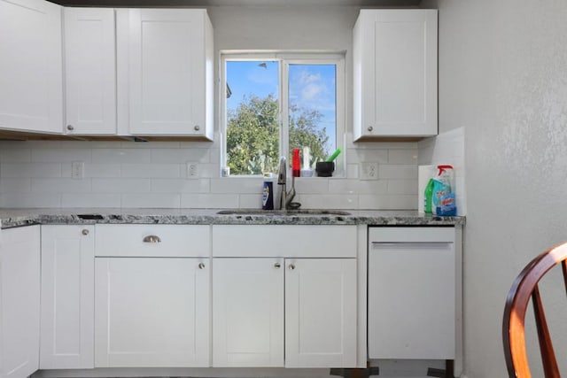 kitchen featuring white cabinets, white dishwasher, and sink