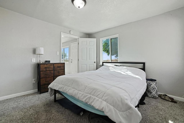 carpeted bedroom featuring a textured ceiling