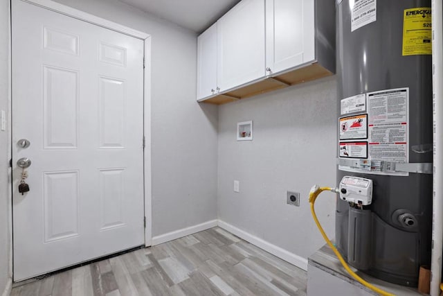 laundry room with cabinets, water heater, light hardwood / wood-style flooring, and electric dryer hookup