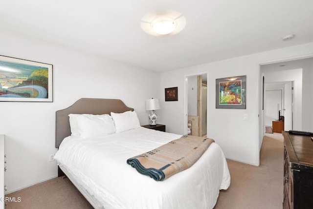 carpeted bedroom featuring ensuite bathroom