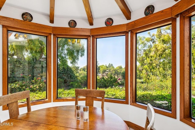 unfurnished sunroom featuring a healthy amount of sunlight and beam ceiling