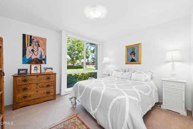 bedroom with light colored carpet