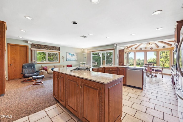 kitchen featuring light carpet, stainless steel dishwasher, plenty of natural light, and ceiling fan