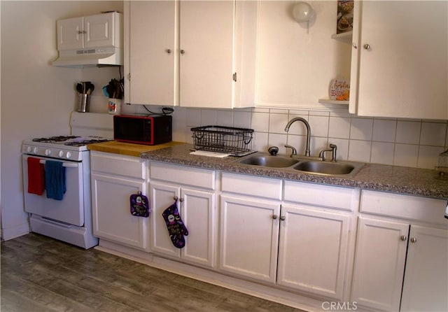 kitchen with backsplash, white gas range, dark wood-type flooring, sink, and white cabinetry