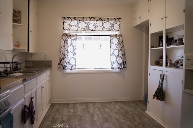 kitchen with sink, white cabinets, and hardwood / wood-style flooring