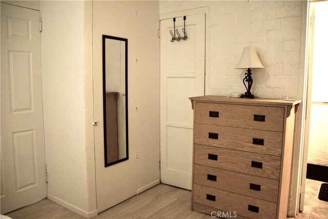 hallway with light hardwood / wood-style floors