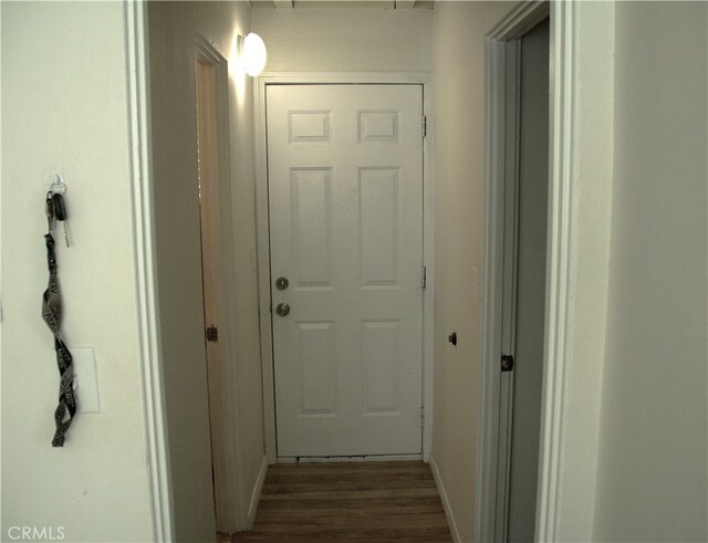 hallway with wood-type flooring