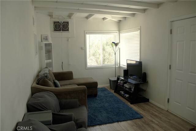 living room featuring wood-type flooring and beam ceiling