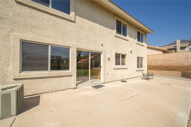 rear view of property with a patio and central air condition unit