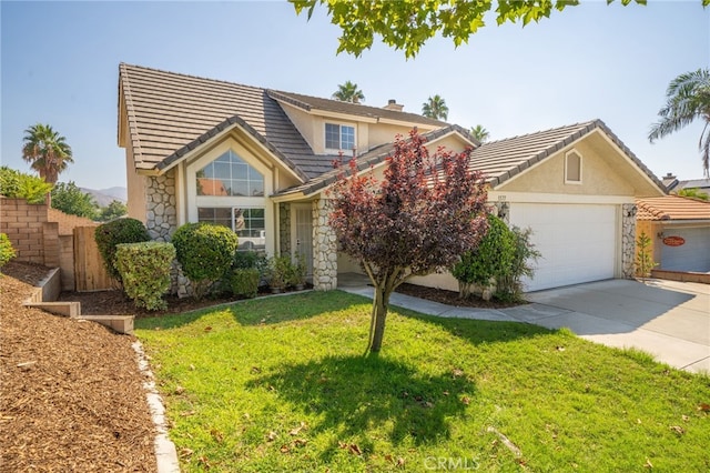 view of front of house featuring a front yard and a garage