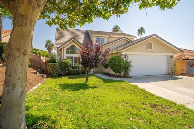 view of property featuring a front yard and a garage