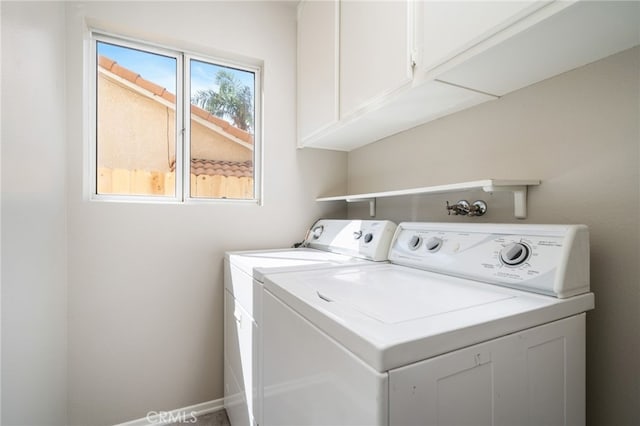 laundry area with cabinets and washing machine and dryer