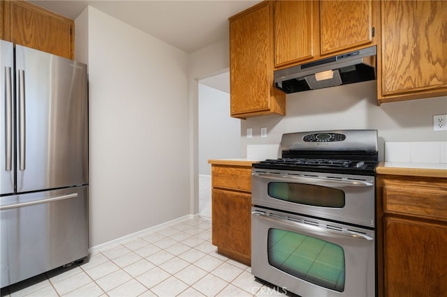 kitchen featuring light tile patterned flooring and stainless steel appliances