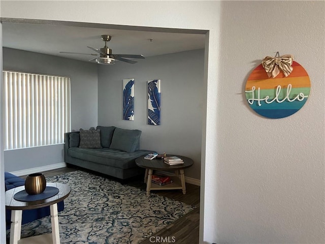 living room featuring hardwood / wood-style floors and ceiling fan