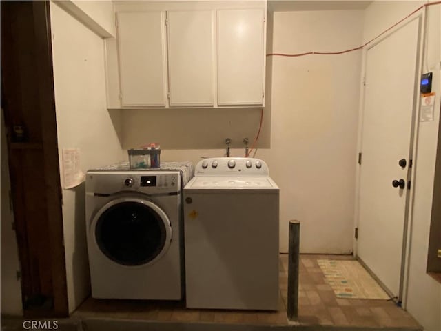 laundry area featuring cabinets and separate washer and dryer