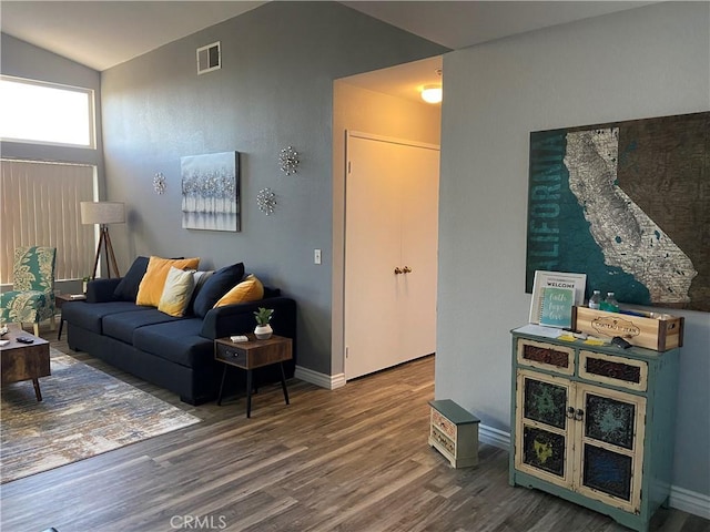 living room featuring hardwood / wood-style floors and lofted ceiling