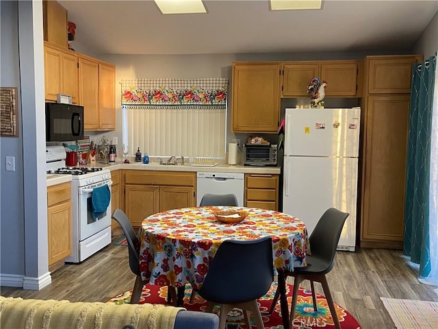 kitchen featuring light hardwood / wood-style floors, white appliances, sink, and light brown cabinets