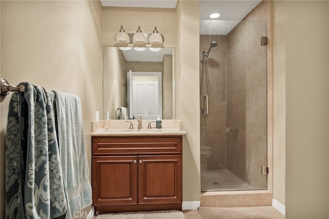 bathroom featuring an enclosed shower, vanity, and toilet